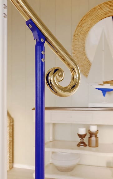 Close-up of a brass scroll handrail end