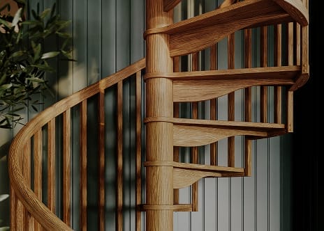 Carpenter spiral staircase with oak wood treads, spindles, and handrail