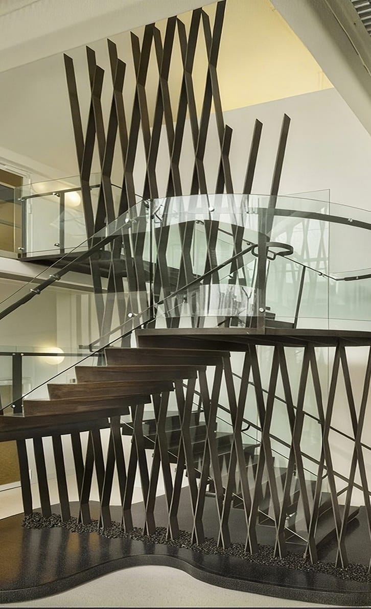 A floor-to-ceiling steel lattice custom staircase