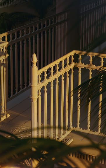 Cream Victorian spiral staircase landing post with decorative finial cap