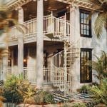 Exterior Victorian spiral staircase on a white columned porch