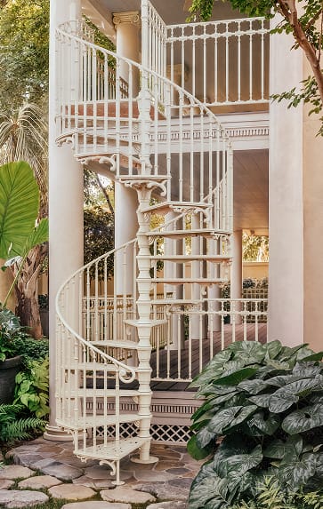 White Victorian spiral staircase with well railing repeating the stair's spindle pattern